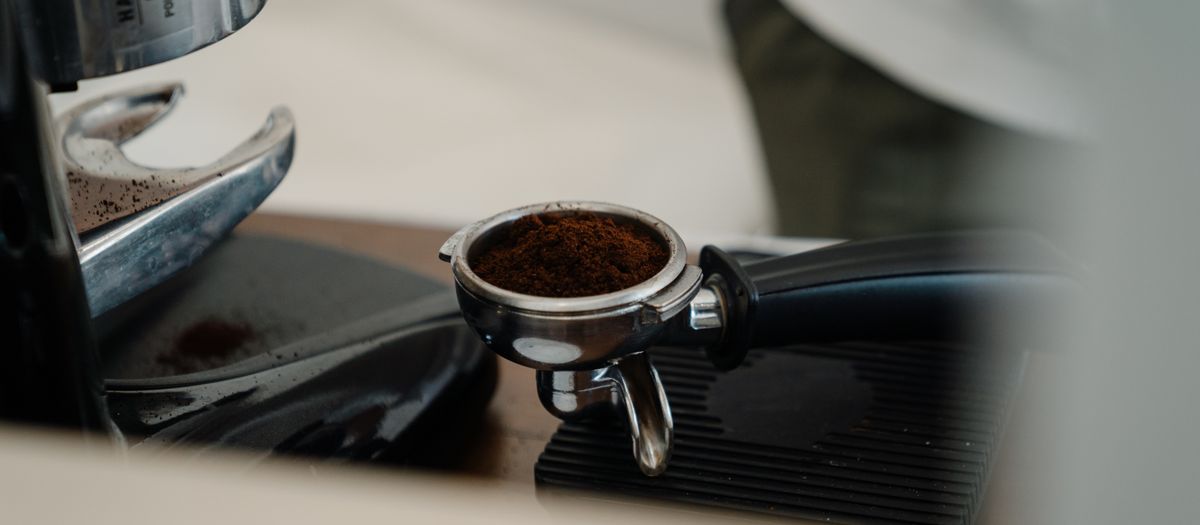 A fresh espresso shot pulling from a portafilter on a home machine.