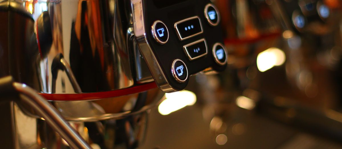 An espresso machine with a temperature display on the front panel.